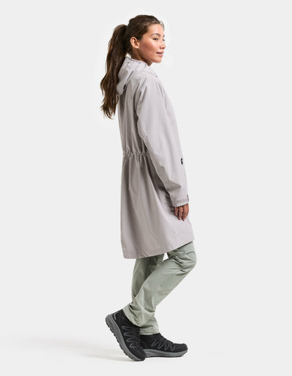 woman wearing pale pink raincoat