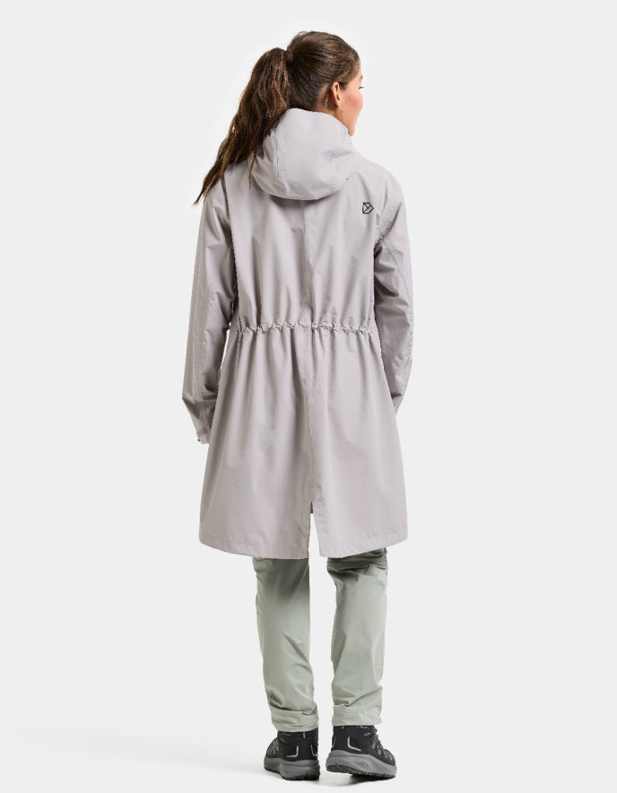 woman wearing pale pink raincoat