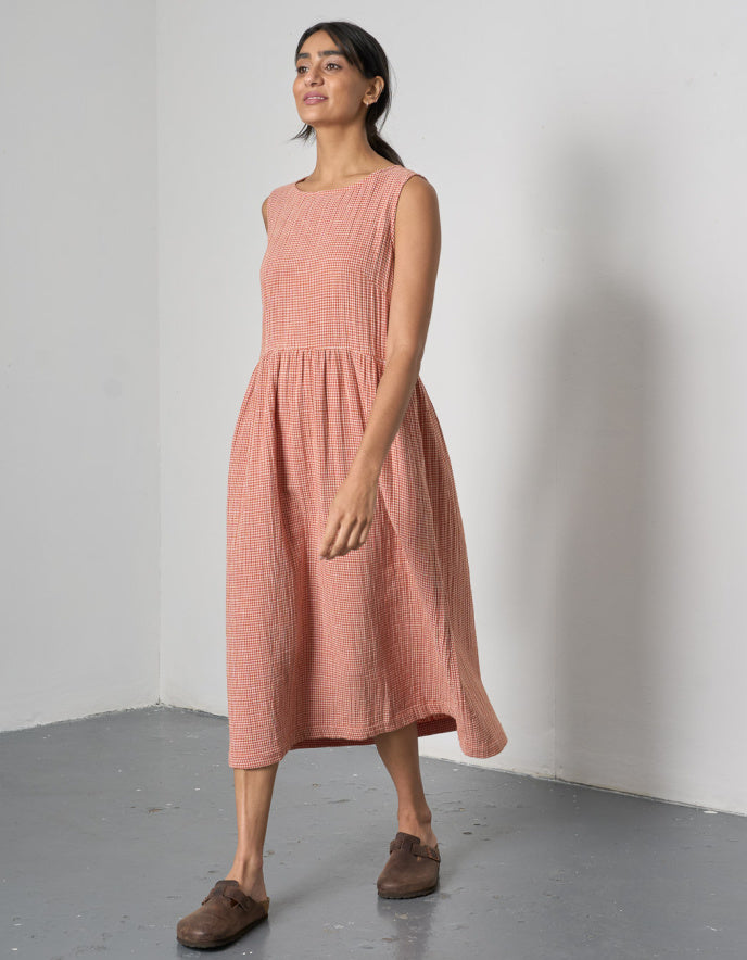 woman wearing sleeveless orange check bubble dress