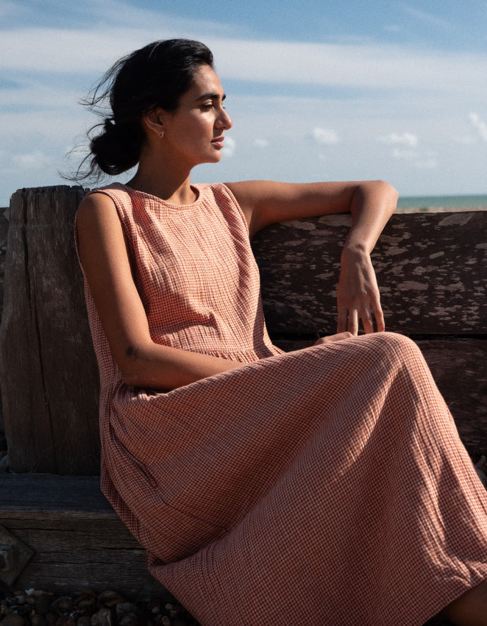woman wearing sleeveless orange check bubble dress