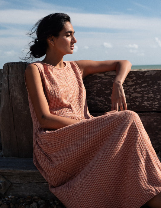 woman wearing sleeveless orange check bubble dress