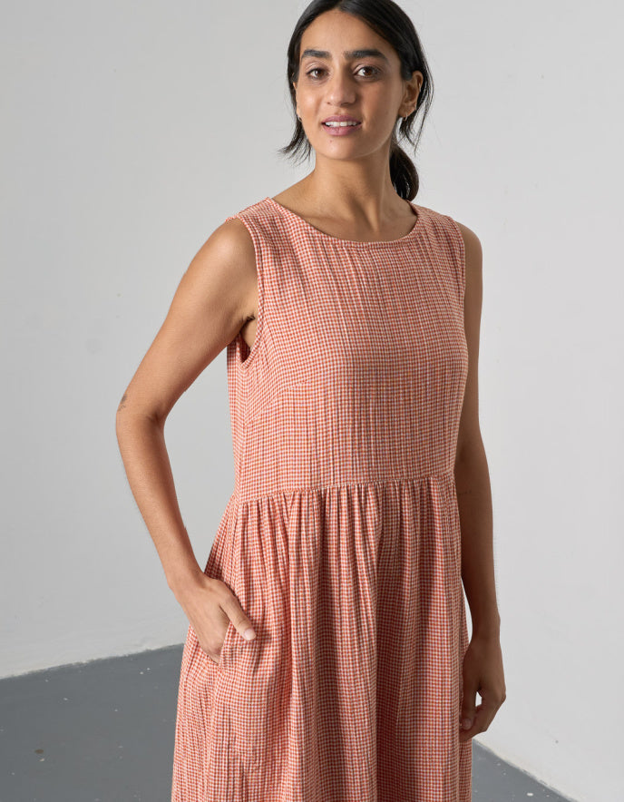 woman wearing sleeveless orange check bubble dress