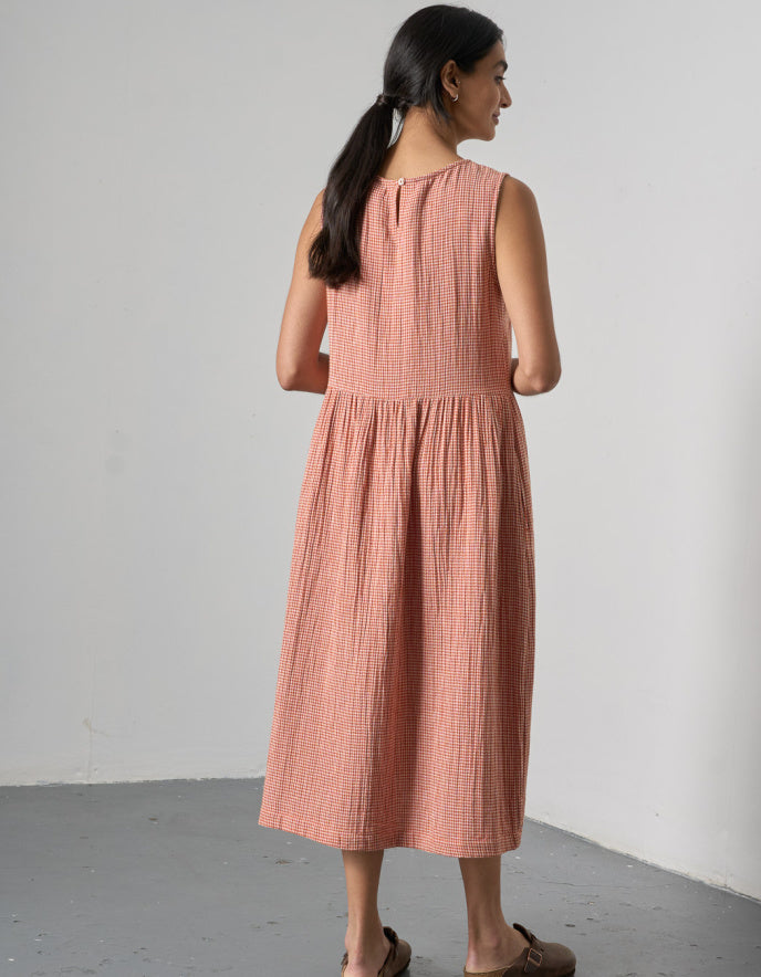 woman wearing sleeveless orange check bubble dress