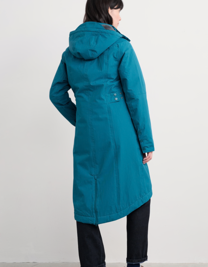 Person wearing a teal raincoat with a hood on a white background