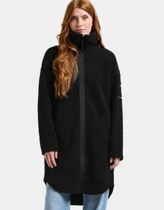 Woman wearing a black sherpa pile fleece coat on a white background