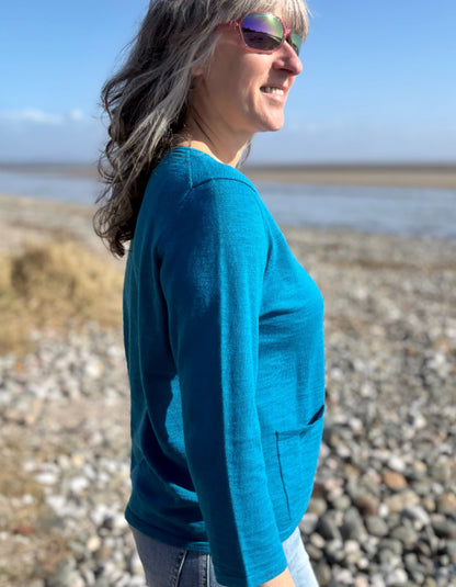 woman wearing turquoise cotton cardigan and vintage barrel leg jeans