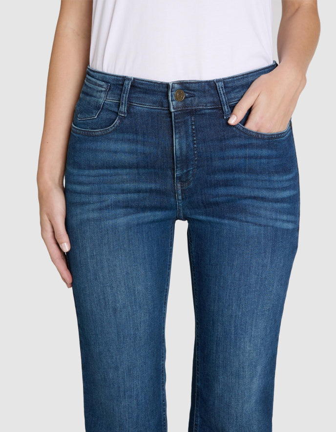 Blue jeans worn by a person on a white background