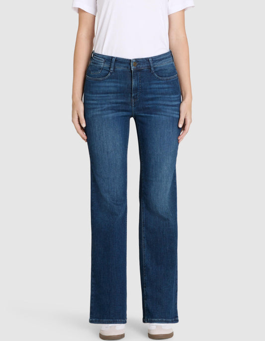 Person wearing blue jeans and a white shirt on a light gray background