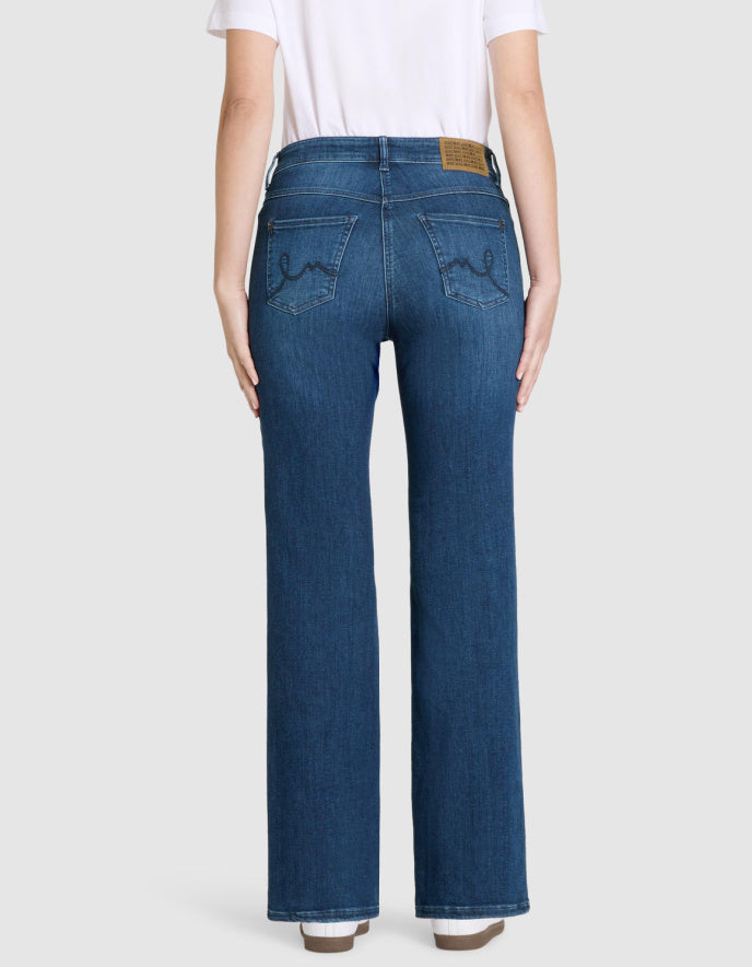 Person wearing blue jeans on a white background