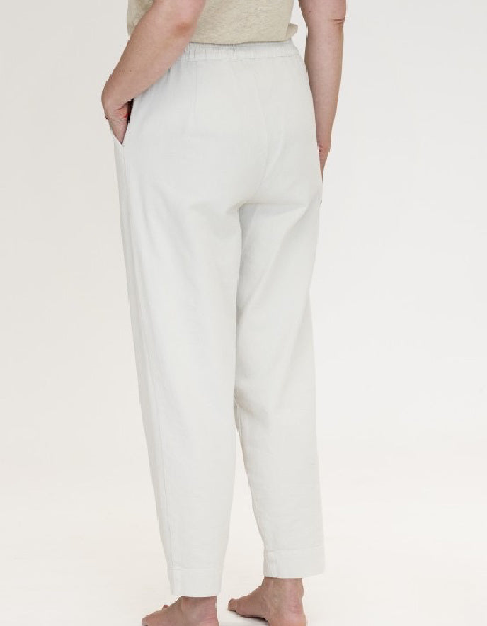 woman wearing natural coloured cotton canvas trousers with elasticated waist
