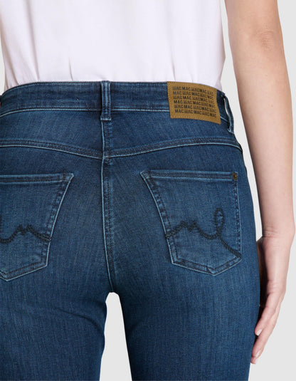 Blue jeans with a brand label on a white background