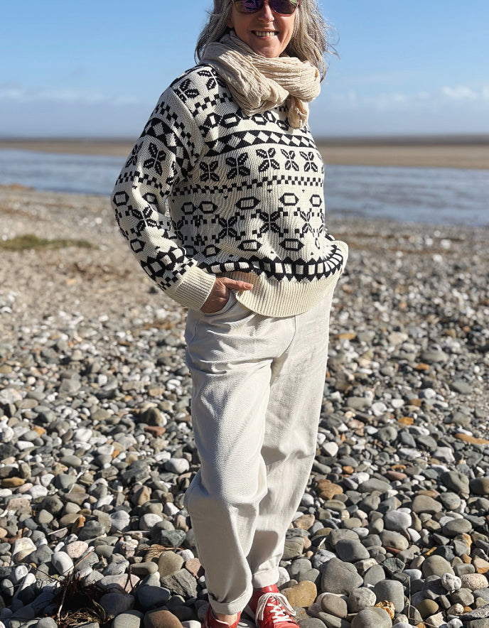 woman wearing natural cotton pants and denim tank on a beach