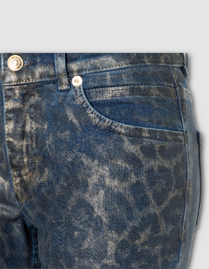 Close-up of blue denim jeans with a subtle pattern on a light gray background