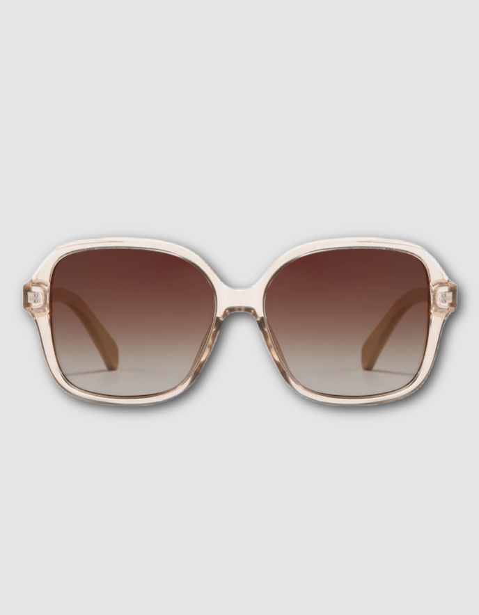 Oversized square sunglasses with a translucent off-white frame and brown gradient lenses, shown against a light gray background.