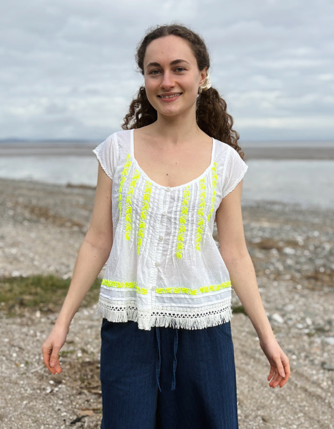 white cotton embroidered top with yellow detail
