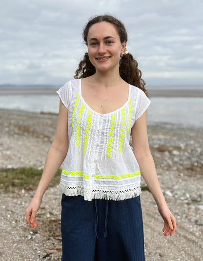 white cotton embroidered top with yellow detail