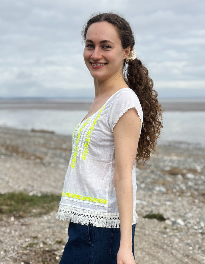 white cotton embroidered top with yellow detail