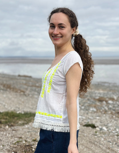white cotton embroidered top with yellow detail