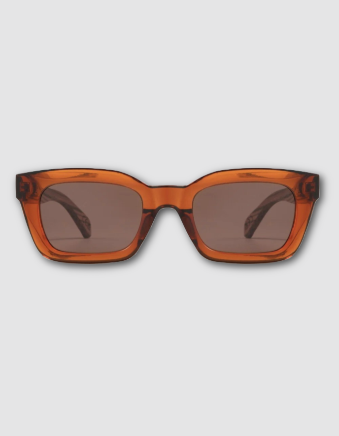 Oversized square sunglasses with a translucent amber-orange acetate frame and dark brown tinted lenses, shown from the front on a light gray background.