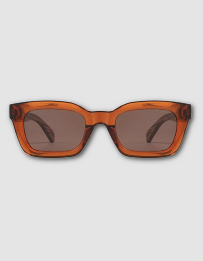 Oversized square sunglasses with a translucent amber-orange acetate frame and dark brown tinted lenses, shown from the front on a light gray background.