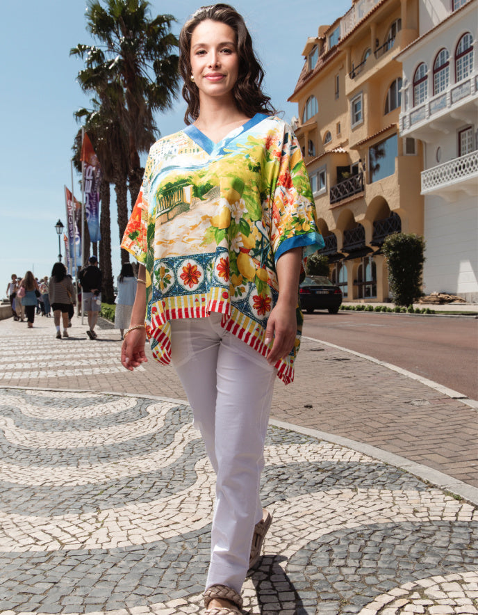 woman wearing wide fit cotton top with v neckline with amalfi coast print