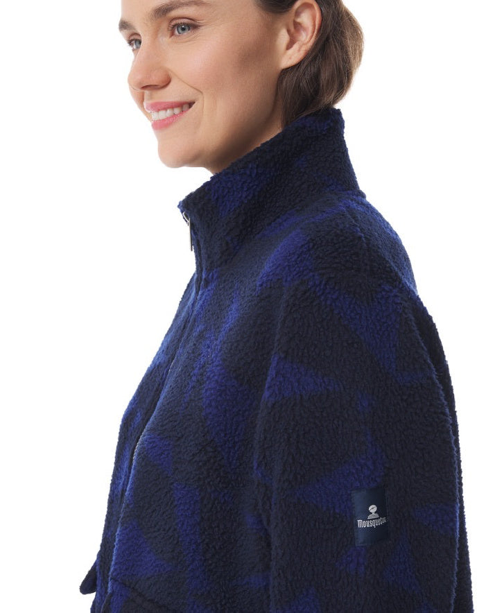 Woman wearing a blue patterned fleece jacket on a white background