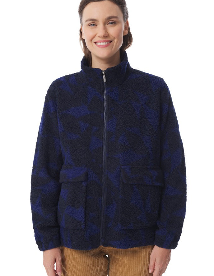 Woman wearing a blue patterned jacket on a white background
