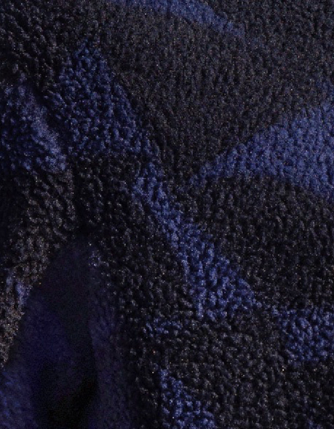 Close-up of textured blue fabric with a subtle pattern