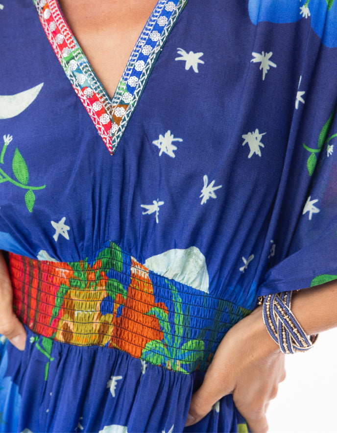 woman wearing a shirred waisted maxi dress with arabian nights print