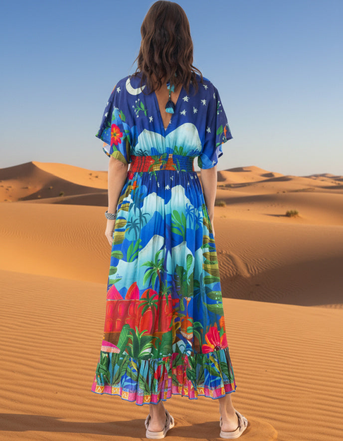 woman wearing a shirred waisted maxi dress with arabian nights print