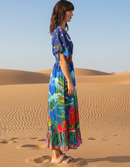 woman wearing a shirred waisted maxi dress with arabian nights print