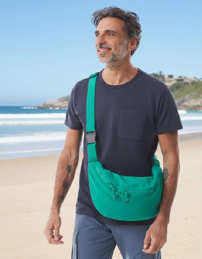 man wearing jade cotton canvas green crossbody bag 