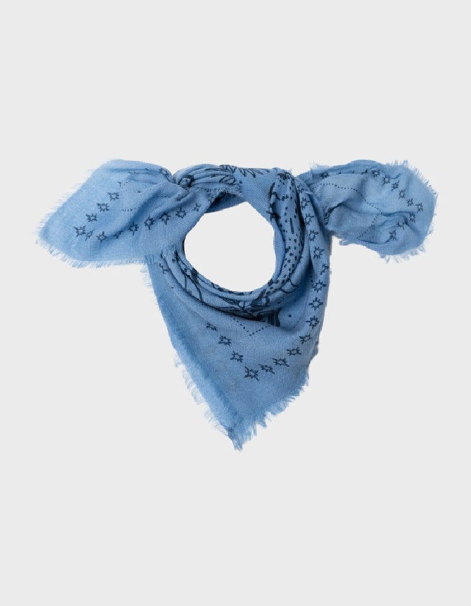 A light blue scarf with a black monogram pattern and frayed edges, styled in a bow shape on a light gray background.