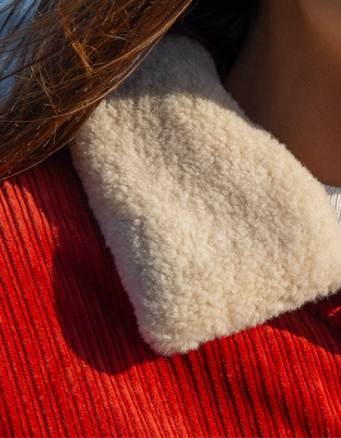 Close-up of a textured white phone case on a red surface