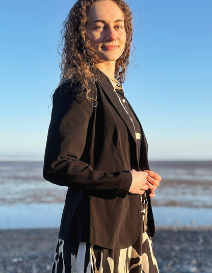 woman wearing black jacket blazer over a zebra print dress