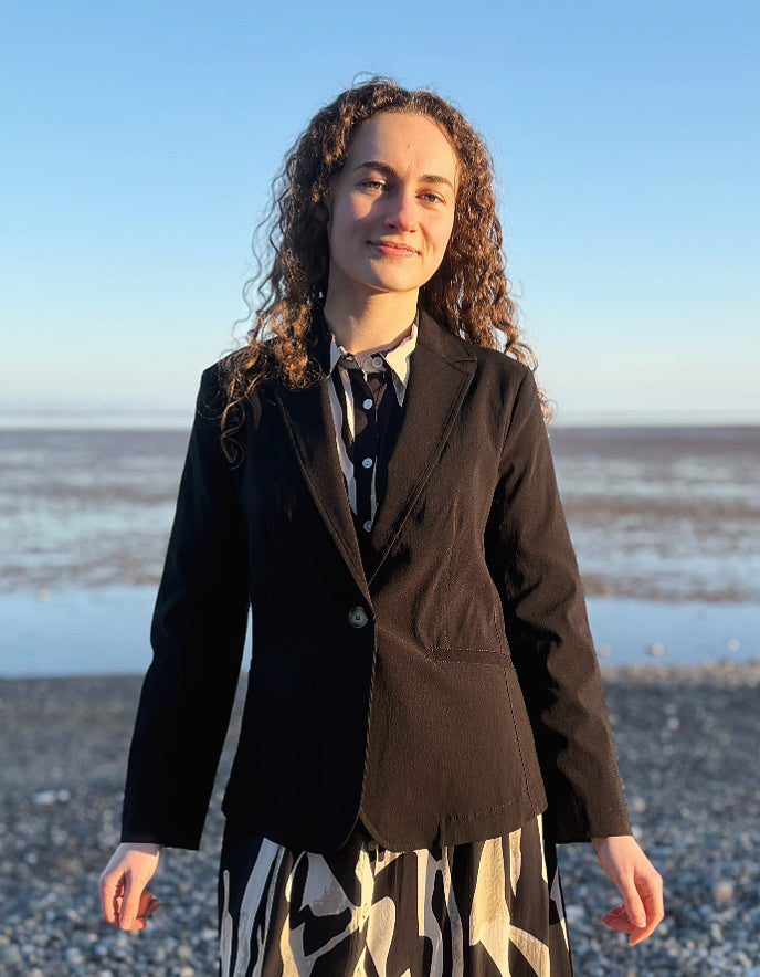 woman wearing black jacket blazer over a zebra print dress