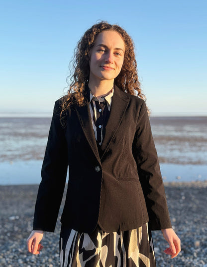 woman wearing black jacket blazer over a zebra print dress