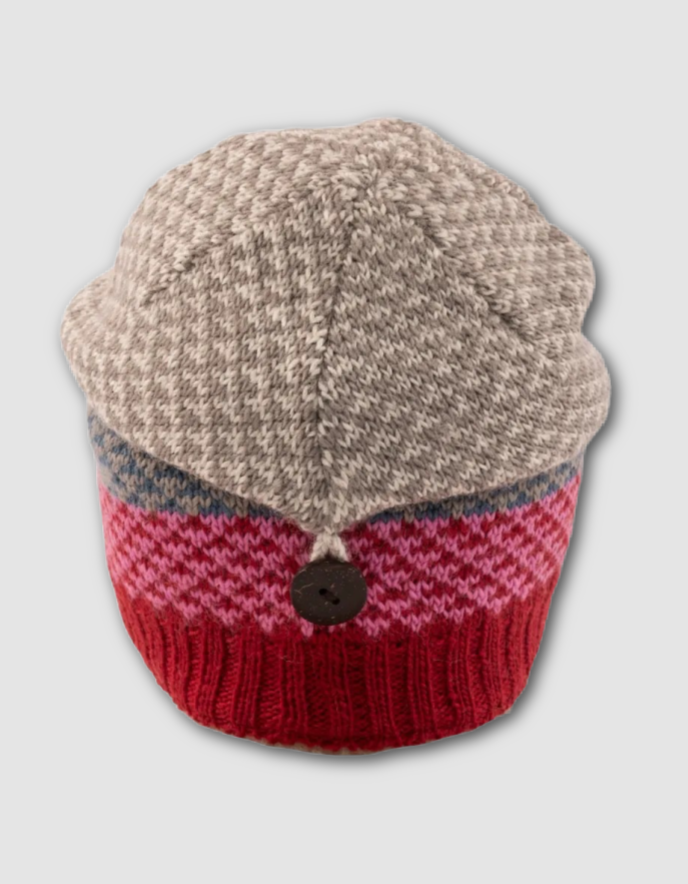 Knitted hat with beige top and red bottom on a light gray background