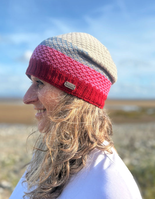 Person wearing a colorful knit beanie in an outdoor setting