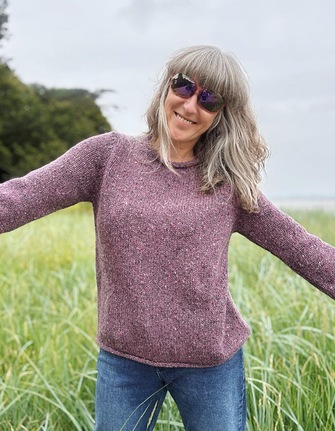 woman wearing donegal tweed dark mauve pink roll neck sweater