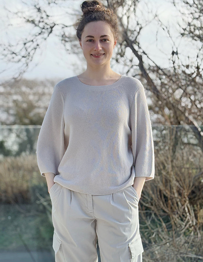 cream knit sweater with crew neckline and 3/4 sleeves