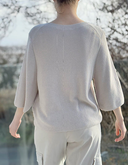 cream knit sweater with crew neckline and 3/4 sleeves