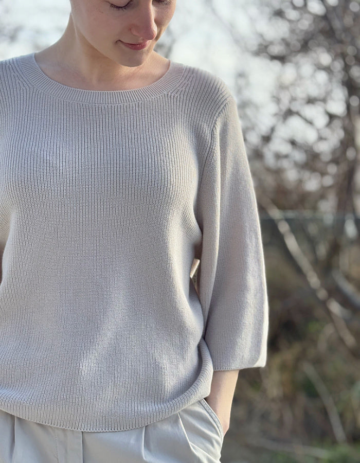 cream knit sweater with crew neckline and 3/4 sleeves