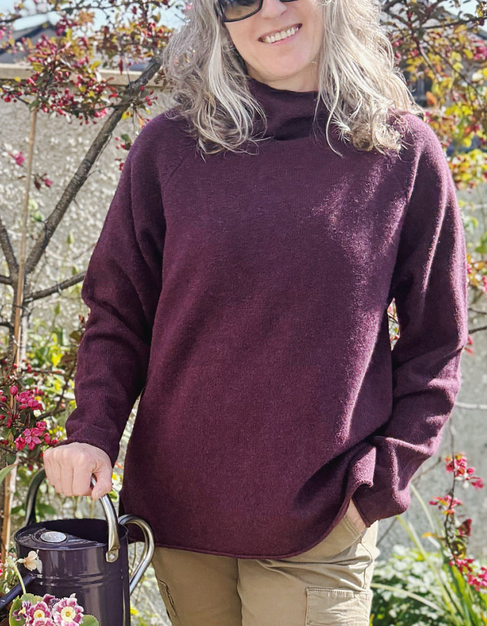 raglan sleeve lambswool sweater, loose fit with mock turtle neckline in black grape. made in Scotland