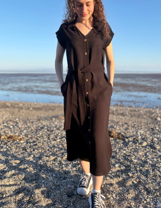 woman wearing black midi length shirt dress