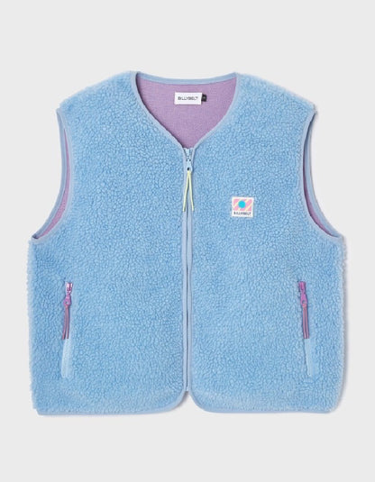 A light blue sherpa fleece vest with a purple inner lining and a small colorful Carhartt logo patch on the left chest, displayed flat against a light gray background.