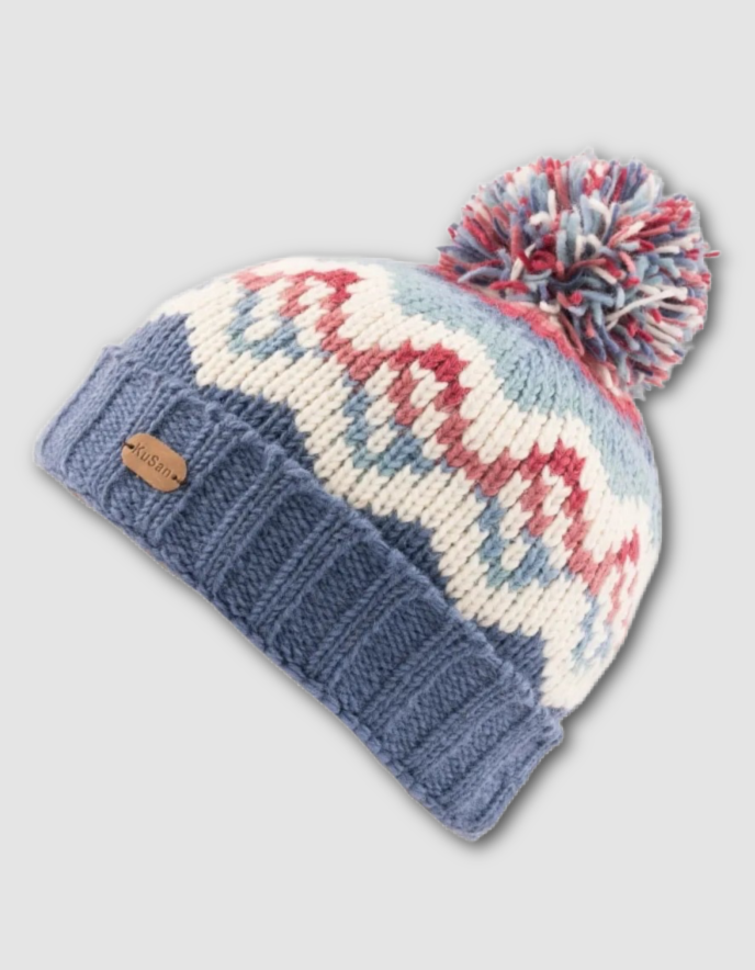 Knitted beanie with a patterned design and pom-pom on a light gray background