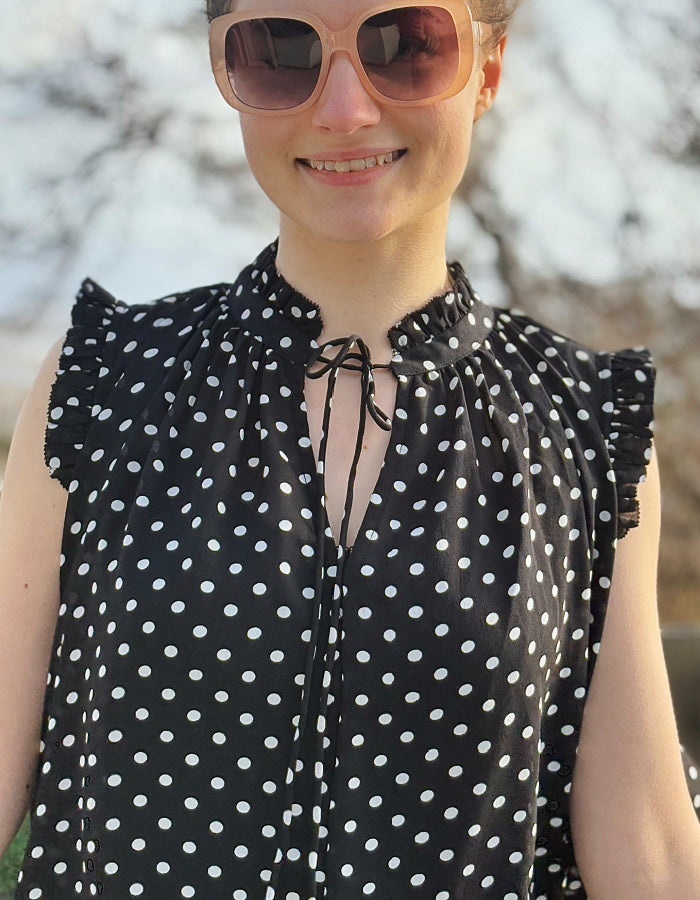 black and white polka dot chiffon sleeveless top with ruffle edged detail