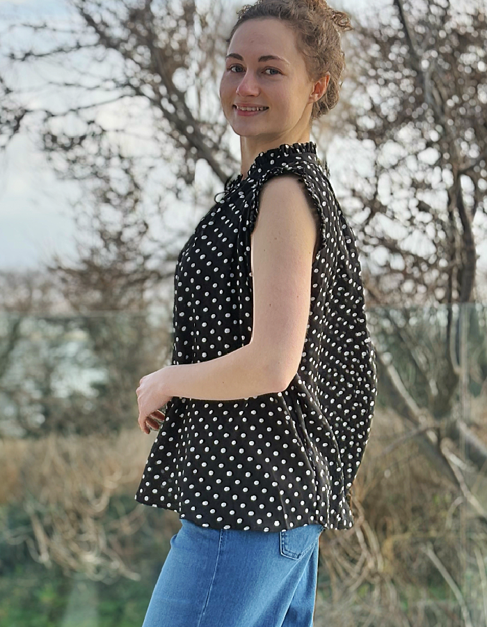 black and white polka dot chiffon sleeveless top with ruffle edged detail