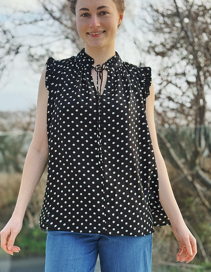 black and white polka dot chiffon sleeveless top with ruffle edged detail